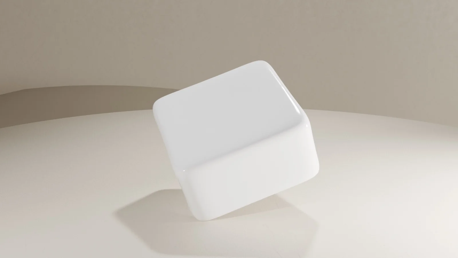 CAD render of the keycap — a rounded cube with a dished top