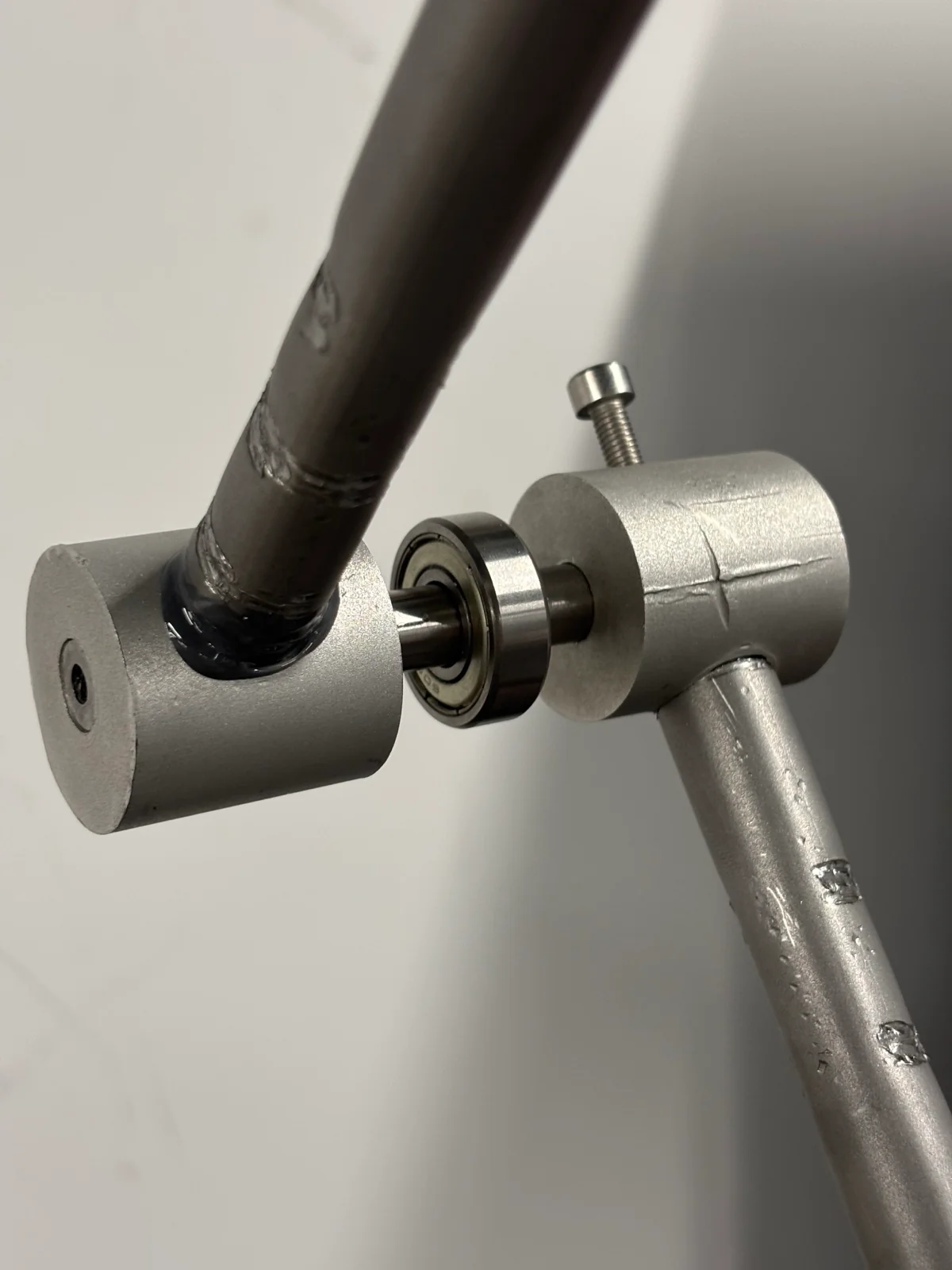 The finished hinge — two cylinders on a shared axle, running on a bearing